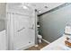 Bathroom featuring a walk-in shower with grab bar, toilet, and decorative wallpaper at 1958 Cameron Heights Cir, Denver, NC 28037