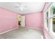 Bedroom with light pink walls, carpet, a window, and an open doorway at 1958 Cameron Heights Cir, Denver, NC 28037