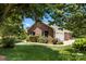 Charming brick home featuring a well-manicured lawn, lush landscaping, and an attached two-car garage at 1958 Cameron Heights Cir, Denver, NC 28037