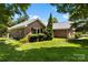 Picture of well maintained lawn and landscaping with a brick home and a two car garage at 1958 Cameron Heights Cir, Denver, NC 28037