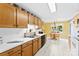 Charming kitchen with white appliances, double basin sink, and tile flooring at 1958 Cameron Heights Cir, Denver, NC 28037