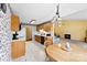 Bright kitchen with tile flooring, laminate cabinets, and adjacent living room at 1958 Cameron Heights Cir, Denver, NC 28037
