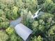 Aerial view of a home and car port surrounded by dense forest at 209 Falcon Dr, Concord, NC 28025