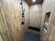 Modern bathroom featuring wood tile walls, black fixtures, and sleek shower at 209 Falcon Dr, Concord, NC 28025