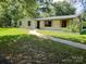 Charming single-story home featuring a well-maintained lawn, tasteful landscaping, and a welcoming walkway at 209 Falcon Dr, Concord, NC 28025