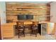 Stylish home office with wood accent wall, built-in shelving, and a beverage refrigerator at 209 Falcon Dr, Concord, NC 28025