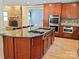 Modern kitchen with a stone fireplace, cooktop island, stainless steel oven, and sleek cabinetry at 209 Falcon Dr, Concord, NC 28025