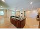 Open-concept kitchen with a large island, cooktop, and stone fireplace, perfect for entertaining at 209 Falcon Dr, Concord, NC 28025