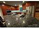 Close-up of the kitchen island featuring a cooktop and barstool seating, perfect for cooking and entertaining at 209 Falcon Dr, Concord, NC 28025