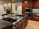 Modern kitchen featuring a large island with gas cooktop, stainless steel appliances, and stone accents at 209 Falcon Dr, Concord, NC 28025