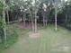 A beautiful parcel of land features mature trees and black fencing at 209 Falcon Dr, Concord, NC 28025