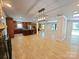 Spacious open-concept living area featuring hardwood floors, and a large kitchen island with bar seating at 209 Falcon Dr, Concord, NC 28025