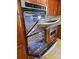 Close-up showcasing the double oven with a modern design and adjacent stainless steel microwave at 209 Falcon Dr, Concord, NC 28025