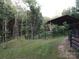 Shed and the surrounding property with a dark fence on the edge of the property at 209 Falcon Dr, Concord, NC 28025