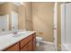 Well-lit bathroom with a single sink vanity and white toilet for cleanliness at 212 Township Dr, Fort Mill, SC 29715