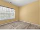 Carpeted bedroom featuring bright natural light and ceiling fan at 212 Township Dr, Fort Mill, SC 29715