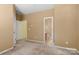 Neutral bedroom with two doorways leading to a walk-in closet and an ensuite bathroom at 212 Township Dr, Fort Mill, SC 29715