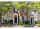 Inviting townhouse featuring a brick facade, neutral siding and classic black shutters at 212 Township Dr, Fort Mill, SC 29715