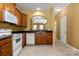 Functional kitchen featuring wooden cabinets and white appliances at 212 Township Dr, Fort Mill, SC 29715