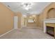 Spacious living room featuring fireplace, modern ceiling fan and open archway to the kitchen at 212 Township Dr, Fort Mill, SC 29715