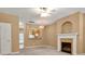 Cozy living room featuring fireplace, modern ceiling fan and open archway to the kitchen at 212 Township Dr, Fort Mill, SC 29715
