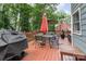 Outdoor deck with patio furniture and grill, surrounded by trees, perfect for outdoor entertaining at 2133 Highland View Ln, Charlotte, NC 28214