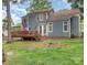 Spacious backyard featuring a deck, lush lawn, and a view of the home's exterior at 2133 Highland View Ln, Charlotte, NC 28214