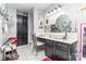Bathroom with dark vanity, granite countertop, vessel sink, and decorative mirror at 2133 Highland View Ln, Charlotte, NC 28214
