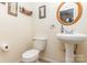 Half bathroom with pedestal sink, round mirror, and neutral wall color at 2133 Highland View Ln, Charlotte, NC 28214