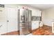 Kitchen featuring stainless refrigerator, white cabinets, and a doorway entrance at 2133 Highland View Ln, Charlotte, NC 28214