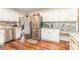 View of kitchen featuring stainless refrigerator, white cabinets, and a workstation area at 2133 Highland View Ln, Charlotte, NC 28214