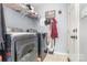 Well organized laundry room featuring washer, dryer, shelving, and accessories hanging on the wall at 2133 Highland View Ln, Charlotte, NC 28214