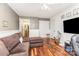 Spacious living room features hardwood floors, wainscoting, access to other rooms, and a television at 2133 Highland View Ln, Charlotte, NC 28214
