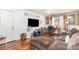 Versatile living room and office space featuring wood floors, a fan, and a large television at 2133 Highland View Ln, Charlotte, NC 28214