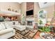 Inviting living area with a brick fireplace, large windows, and an open layout with hardwood floors at 2133 Highland View Ln, Charlotte, NC 28214