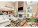 Inviting living area with a brick fireplace, large windows, and an open layout with hardwood floors at 2133 Highland View Ln, Charlotte, NC 28214