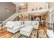 Open-concept living room featuring hardwood floors, a staircase, and a view into the dining area at 2133 Highland View Ln, Charlotte, NC 28214