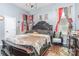 Bedroom features a large bed, stylish decor, and ample natural light at 2133 Highland View Ln, Charlotte, NC 28214