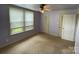 This bedroom has two closets, a ceiling fan, and natural light from the window at 2411 Rebecca Ave, Charlotte, NC 28208