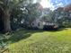 A quaint home surrounded by lush greenery, featuring well-maintained grounds and mature trees at 2411 Rebecca Ave, Charlotte, NC 28208
