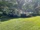Charming home exterior featuring lush landscaping, a manicured lawn, and a cozy front porch at 2411 Rebecca Ave, Charlotte, NC 28208