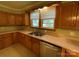 Bright kitchen with a stainless steel dishwasher, ample cabinet space, and a double sink at 2411 Rebecca Ave, Charlotte, NC 28208