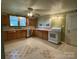 Well-lit kitchen featuring stainless steel appliances, ample cabinet space, and tile flooring at 2411 Rebecca Ave, Charlotte, NC 28208