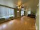 Bright and airy living room featuring hardwood floors, large windows, and a cozy fireplace at 2411 Rebecca Ave, Charlotte, NC 28208