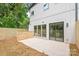 A modern home featuring a concrete patio with sliding glass doors and a newly installed wooden fence at 2733 Cowles Rd, Charlotte, NC 28208