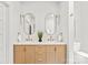 Elegant bathroom with dual sinks, modern light fixtures, and wood vanity at 2733 Cowles Rd, Charlotte, NC 28208