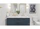 Bathroom featuring double sinks with navy blue vanity and gold framed mirrors at 2733 Cowles Rd, Charlotte, NC 28208