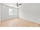 Bright, empty bedroom featuring hardwood floors, white walls, and two windows at 2733 Cowles Rd, Charlotte, NC 28208