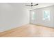 Bedroom features two large windows, hardwood floors, and a ceiling fan at 2733 Cowles Rd, Charlotte, NC 28208