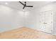 Minimalist bedroom with wood flooring, ceiling fan, and large closet at 2733 Cowles Rd, Charlotte, NC 28208